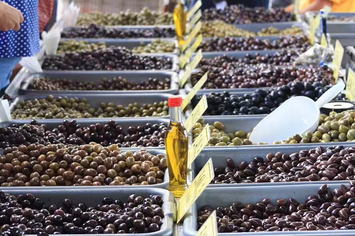 Athens market olive stalls with bottles of olive oil, a highlight of the Taste of Athens small-group food tour