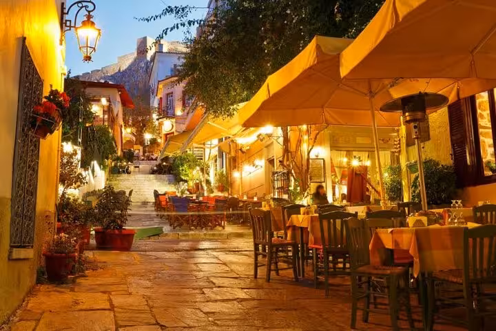 Monastiraki street cafés at dusk under umbrellas, Athens by Night walking tour with local food and lights