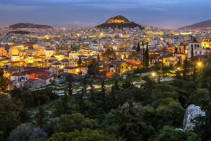 Athens city skyline at dusk, ideal pickup point for private transfer from Athens to Thessaloniki by car