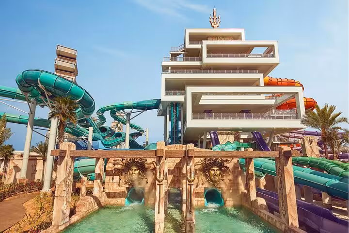 Aquaventure Waterpark Dubai tower and green slides at Atlantis Super Pass entrance lagoon view