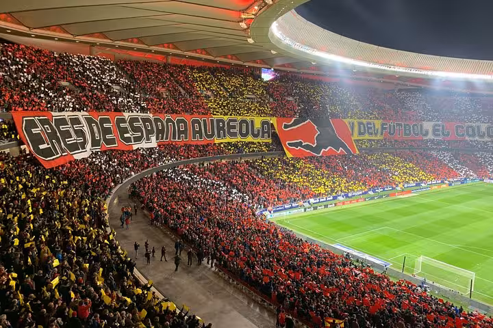 Crowd tifo inside Civitas Metropolitano during an Atletico Madrid match, part of a local fan experience