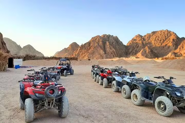 ATV quad bikes lined up at Hurghada desert camp before safari adventure tour and camel ride experience