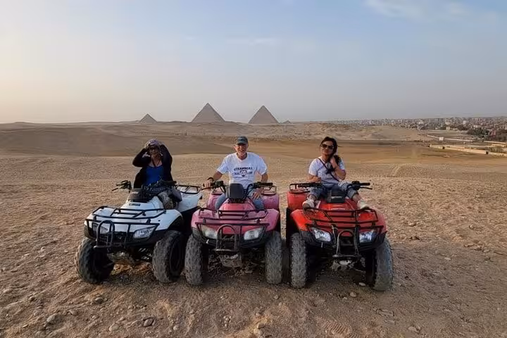 ATV quad biking at Giza Desert with Great Pyramids backdrop on private adventure tour with lunch and camel ride