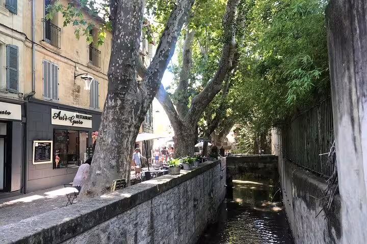 Shaded canal walkway in Avignon old town, ideal stop on a self-guided e-scavenger hunt city tour