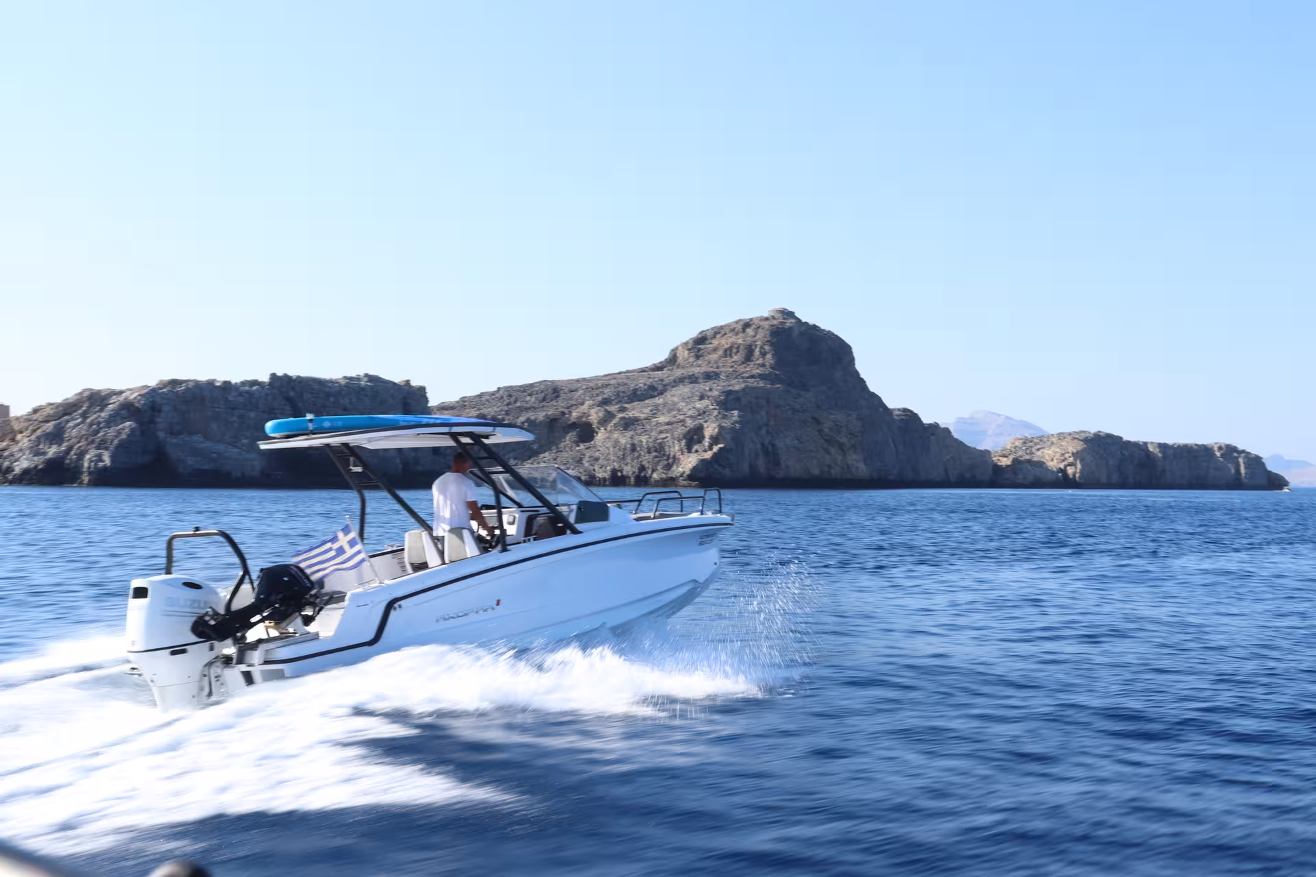 Axopar 25 CT speedboat cruising the Aegean off Lindos, Rhodes, on Discover Gems of Lindos private boat tour