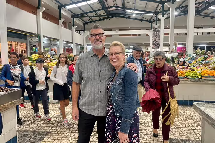 Visitors enjoy a vibrant market experience during the Private Azeitão Cheese Workshop, Wine Tasting & Sesimbra Tour.