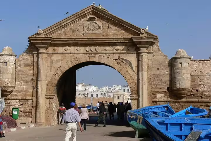 Bab Marrakech gate in Essaouira with blue fishing boats, key stop on private day trip from Marrakech