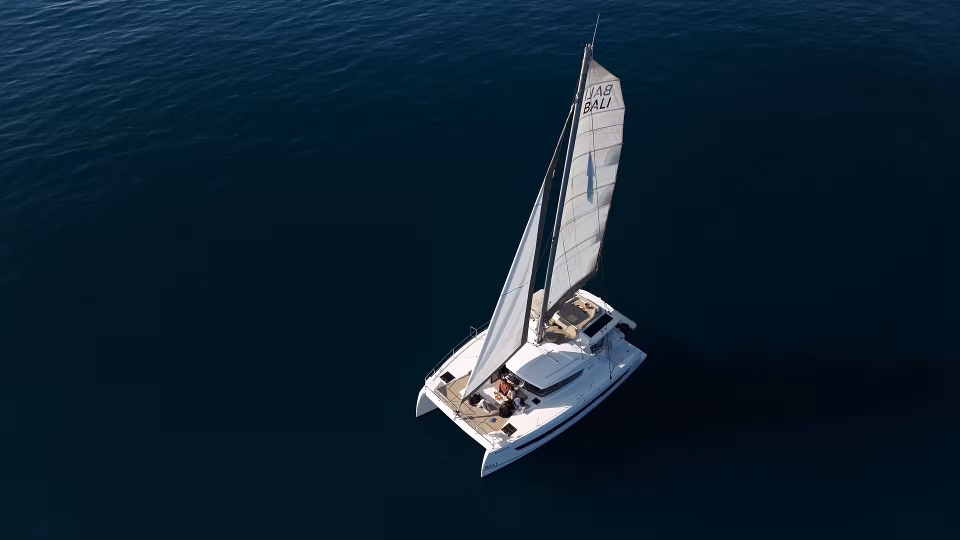 Aerial view of Bali 4.2 private luxury catamaran sailing off Barcelona, perfect for a 2-hour charter experience