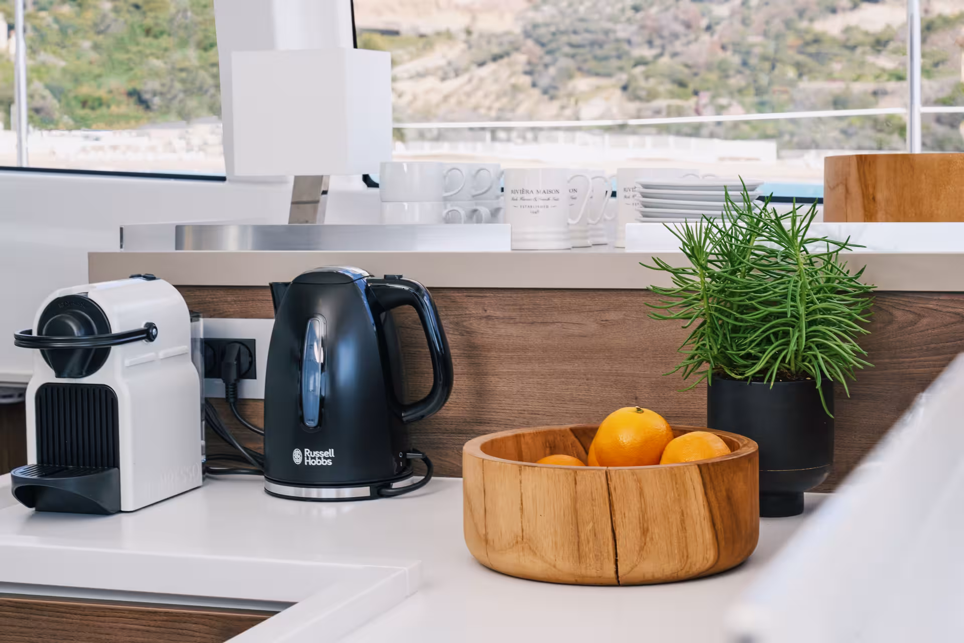 Galley coffee machine, kettle and fresh fruit on Bali 4.2 luxury catamaran Barcelona for a 2-hour private tour