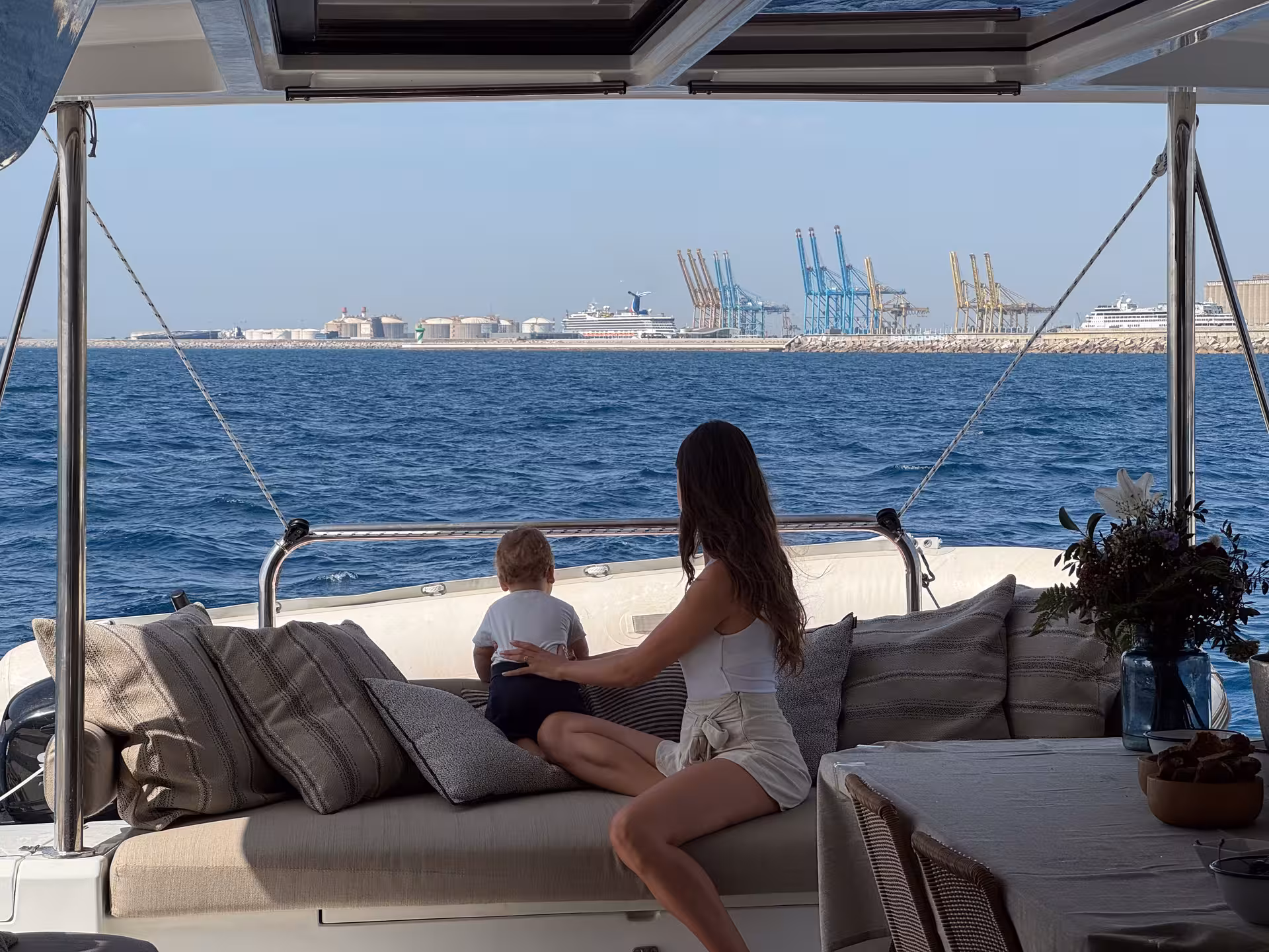 Relaxing lounge on Bali 4.2 private luxury catamaran Barcelona cruise with sea views and Port of Barcelona skyline