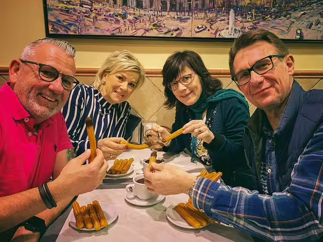 Group enjoying churros and hot chocolate in a cozy Barcelona tavern during a Food & Drink Private Tour.