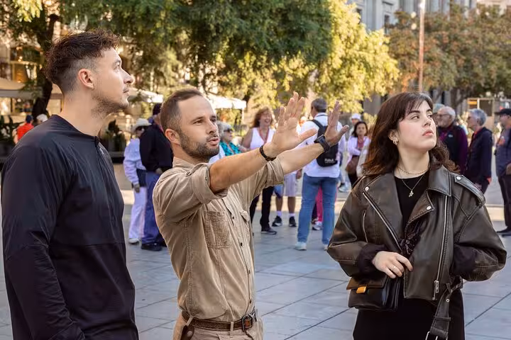 Local guide explaining landmarks to guests in Barcelona Old Town on a small group Gothic Quarter and El Born tour