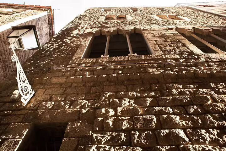 Historic stone facade in Barcelona's Jewish Quarter, capturing medieval architecture on the Private Religious Tour.