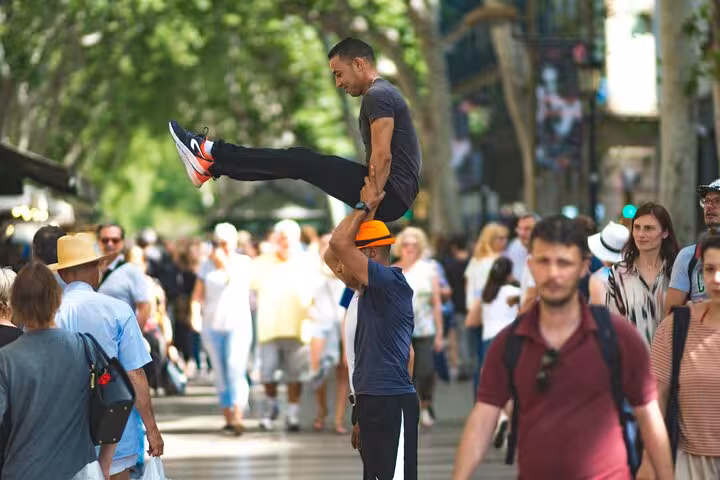 Enjoy street performers entertaining crowds along vibrant Las Ramblas on a private Barcelona day tour by car.