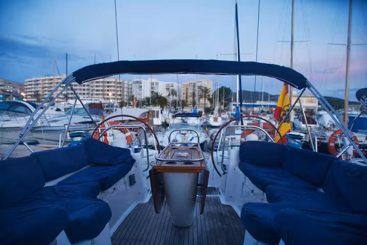 Spacious yacht cockpit with cushioned seating in Barcelona marina, private luxury sailing tour for 12