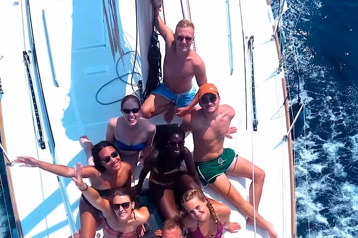 Group of friends sunbathing on a private sailboat in Barcelona, open bar and snacks, max 9 guests