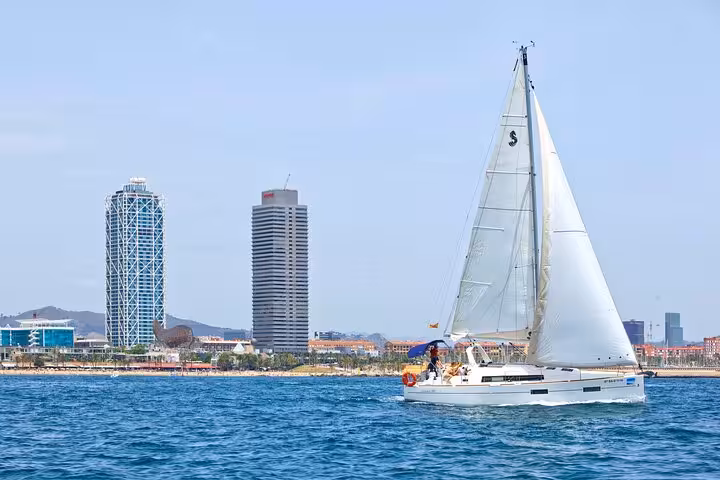 Private sailing yacht cruising Barcelona waterfront near Port Olímpic, open bar and snacks for up to 9