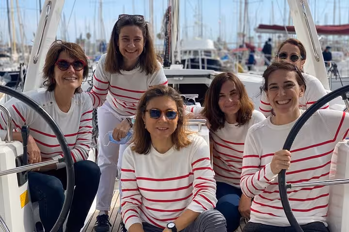 Group photo on yacht at Barcelona Marina during a 2-hour sailing tour with open bar and snacks included