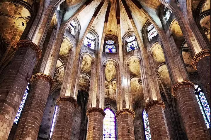 Gothic architecture of Barcelona's Santa Maria del Mar Basilica interior with stunning arches and stained glass windows.
