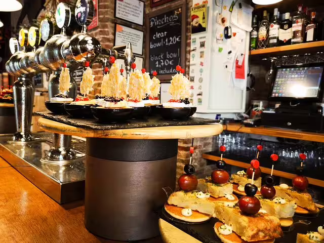 Assorted tapas and pinchos displayed in a traditional Barcelona tavern, highlighting the vibrant local food and drink culture.