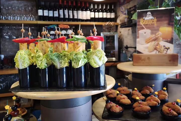 A colorful display of tapas with fresh vegetables and skewers in a traditional Barcelona tavern, perfect for a private food and drink tour.