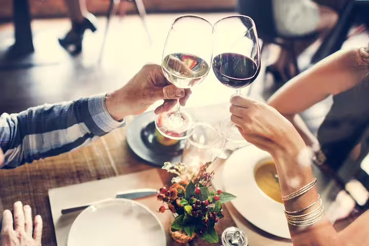 Couple toasting with wine during a tapas dinner on the Private Barcelona Walking Tour with Flamenco Show.