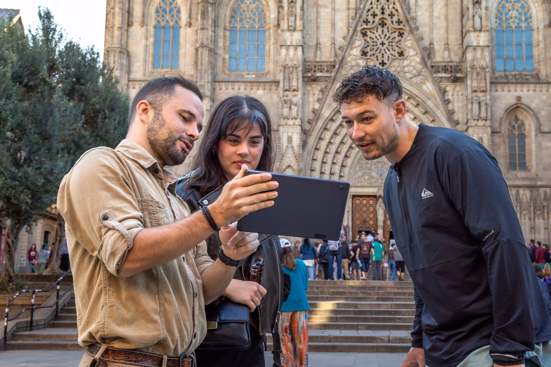 Tour guide shows map to guests in Barcelona Old Town by Gothic Cathedral, must-see highlights walk