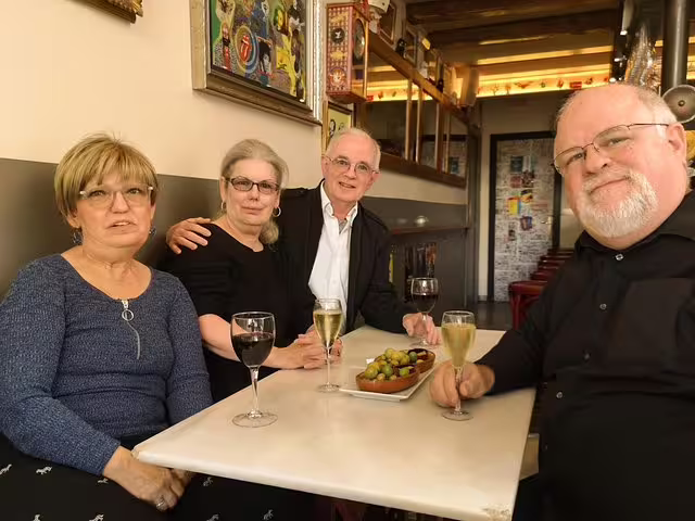 Group enjoying wine and tapas in a cozy traditional Barcelona tavern during a private food and drink tour.