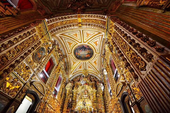 Ornate gold interior of a historic church on the Gold Route in Minas Gerais, showcasing baroque architecture.