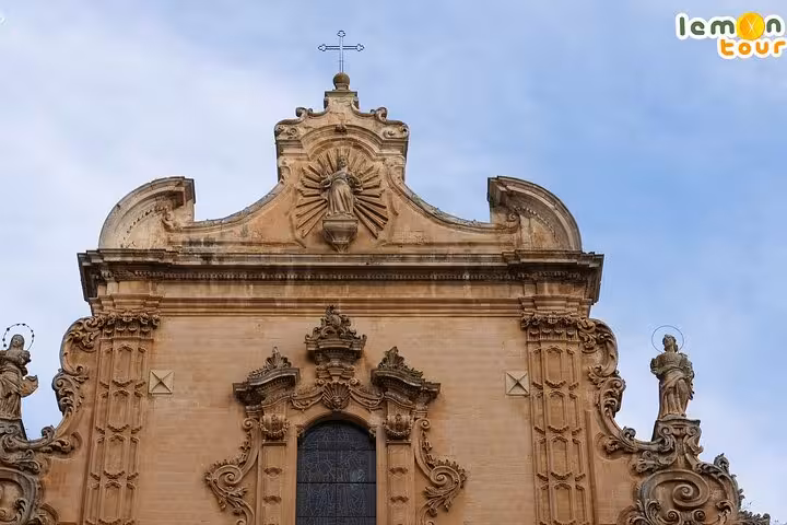 Ornate Baroque architecture of a historic church in Ragusa Ibla, featuring detailed sculptures.