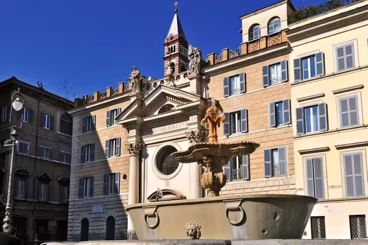 Baroque church façade and ornate fountain in historic Roman piazza visited on Love Affairs and Papal Power small group tour