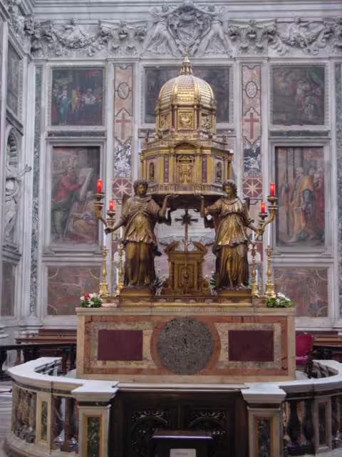 Ornate golden altar with statues and candles inside Basilica di Santa Maria Maggiore, Rome, visited on guided church tour