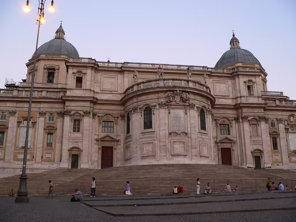 Evening view of Basilica di Santa Maria Maggiore in Rome with grand staircase and domes featured on a guided walking tour