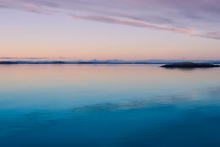 Calm turquoise Ionian Sea at dusk, ideal scenery for a locals BBQ boat cruise and island-hopping tour