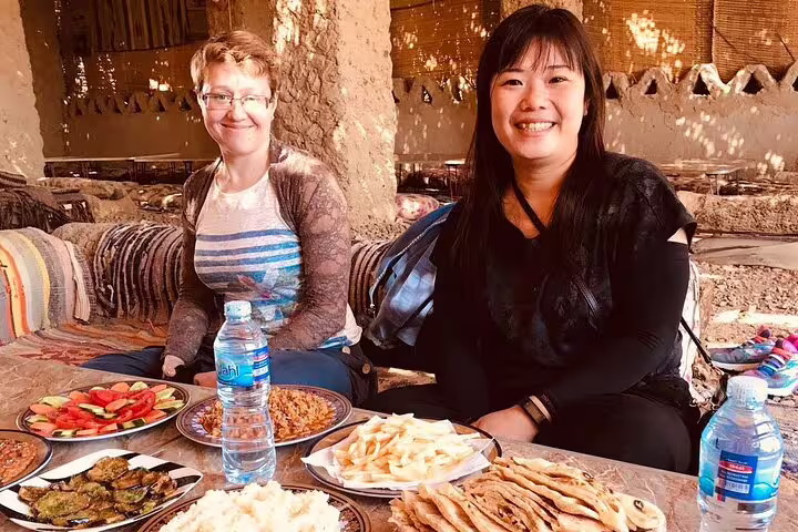 Guests enjoy traditional Bedouin lunch in Bahariya Oasis during White Desert overnight camping tour from Cairo