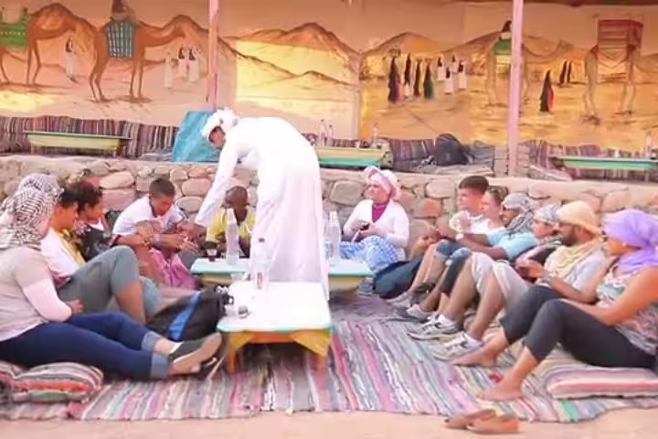 Bedouin host serving tea at desert camp, part of Sharm el Sheikh ATV quad, camel ride, dinner show