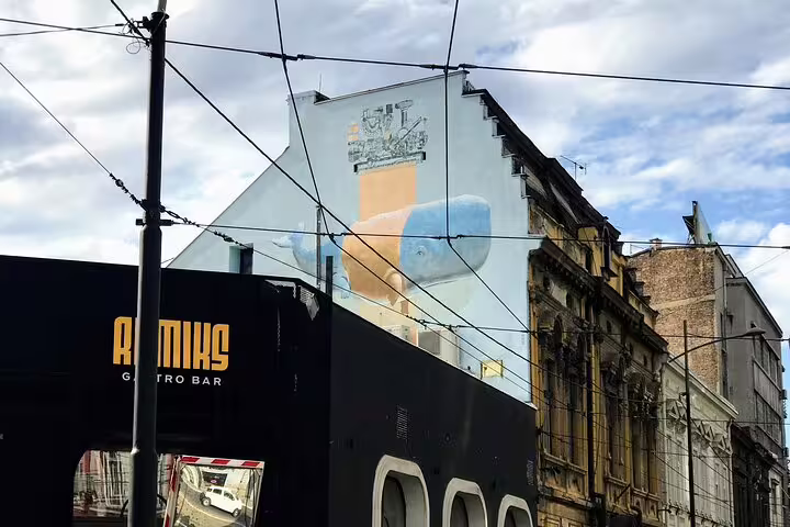 Belgrade street art mural on city facade with tram wires, featured on private walking tour route