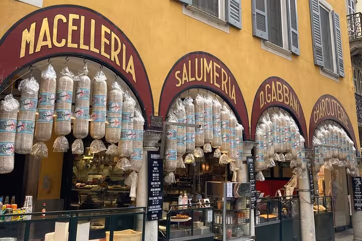 Bellagio old town macelleria and salumeria storefront with hanging cured meats on Lake Como day trip