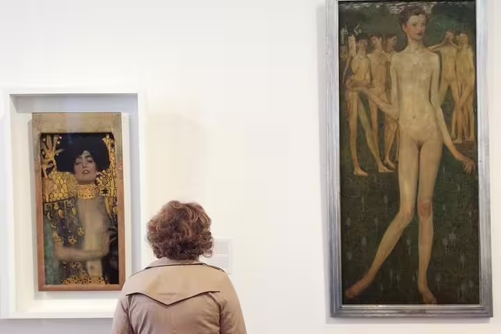 Visitor admires Gustav Klimt's artwork in Vienna's Belvedere, highlighting the tour's focus on Viennese art history.