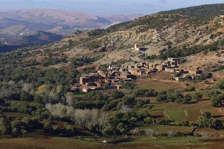 Berber village in Morocco Anti-Atlas mountains with terraced fields, scenic drive on 8-day Sahara tour from Marrakech