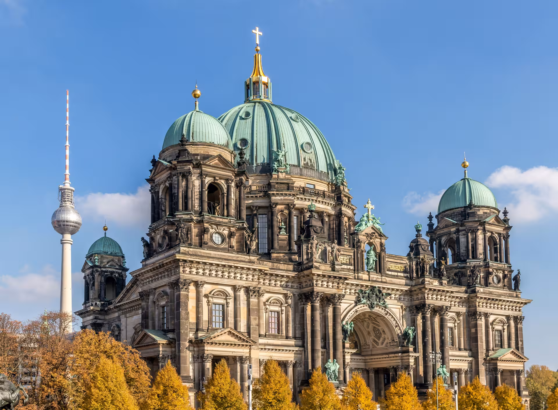 Majestic Berlin Cathedral with iconic TV Tower in the background, perfect for a cultural city walk in Berlin.