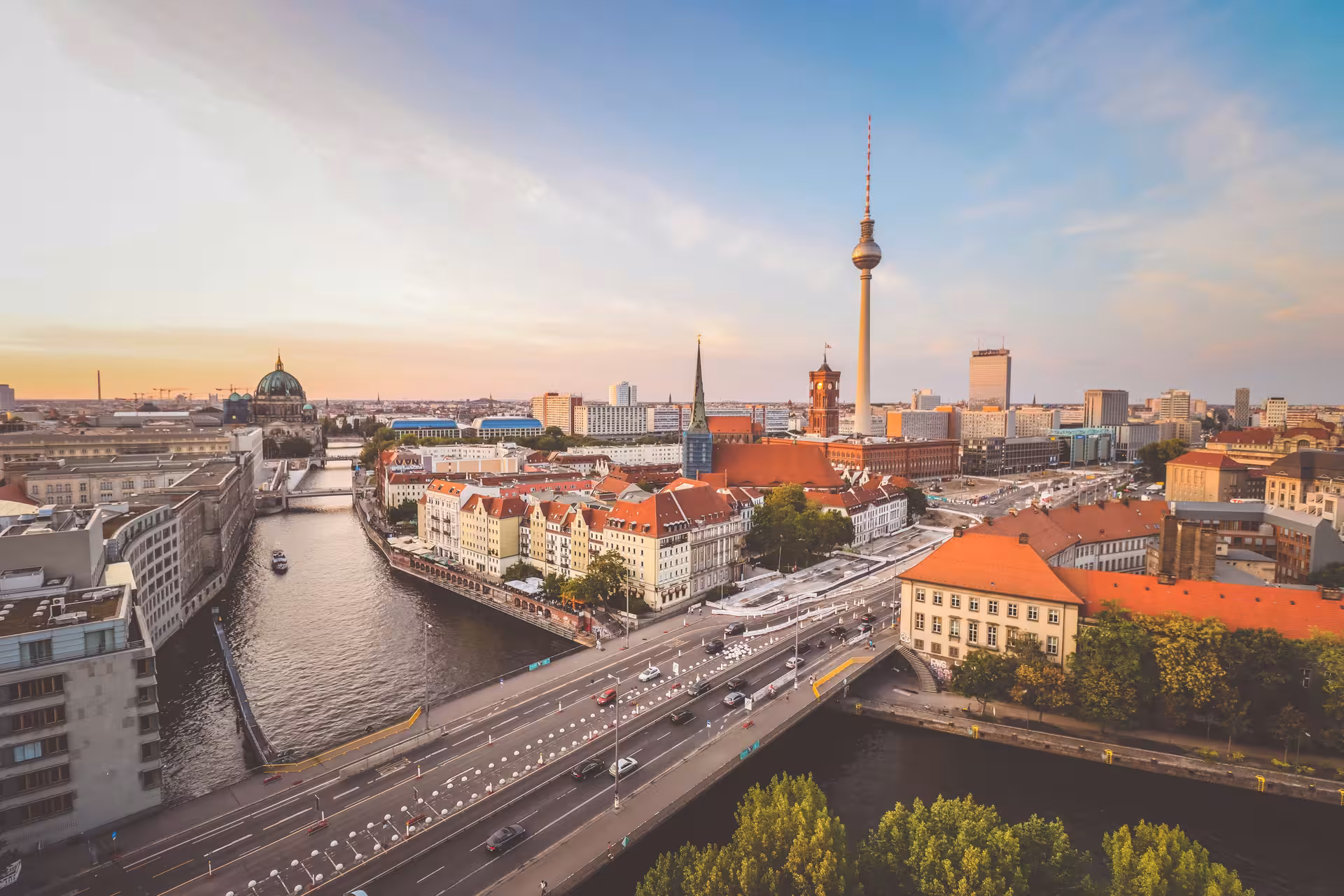 Panoramic view of Berlin skyline at sunset featuring the Spree River and TV Tower, ideal for city exploration.