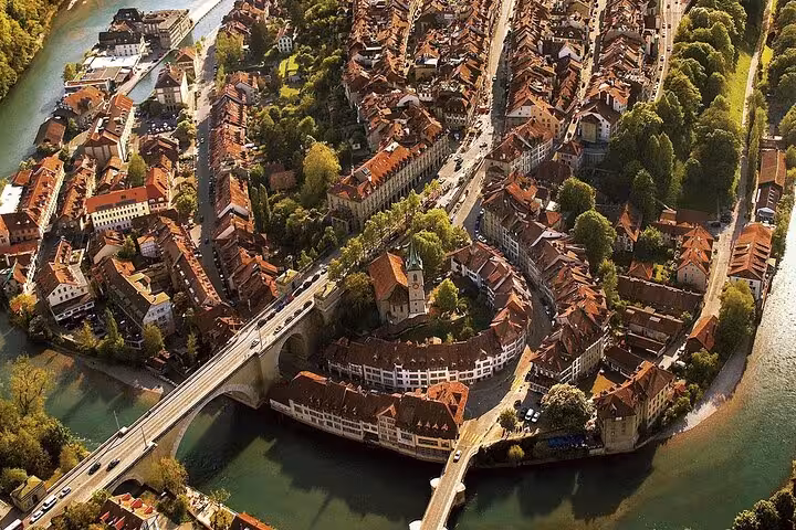 Aerial view of Bern's historic Old Town surrounded by the Aare River, perfect for a Swiss train and guide tour.