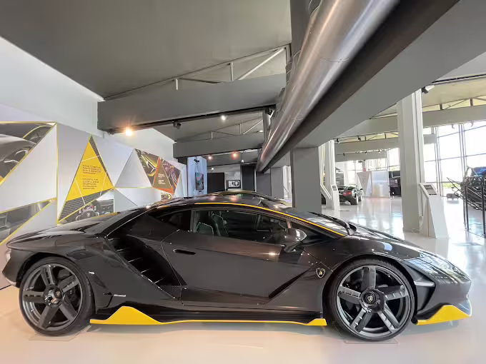 Side profile of a black Lamborghini in the Bologna Lamborghini Museum gallery, part of the combo entry ticket