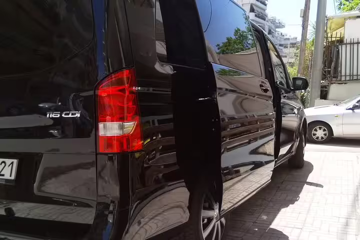 Black luxury van limousine with sliding door open, Athens Airport to Syntagma Square chauffeur transfer