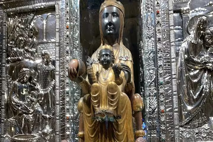 Close-up of the revered Black Madonna statue in Montserrat Monastery, an iconic religious artifact in Catalonia.