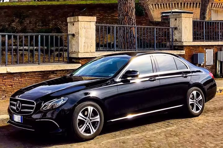 Sophisticated black Mercedes sedan for hire, providing a premium full-day travel experience in the city.
