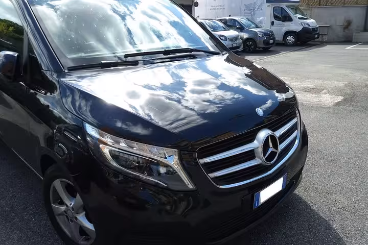 Elegant black Mercedes van ideal for group travel, offering full-day rental with style and comfort.