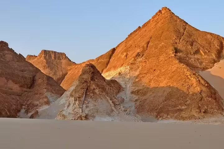 Golden sandstone hills and desert flats in Egypt’s Black and White Desert, scenic stop on 5-day safari