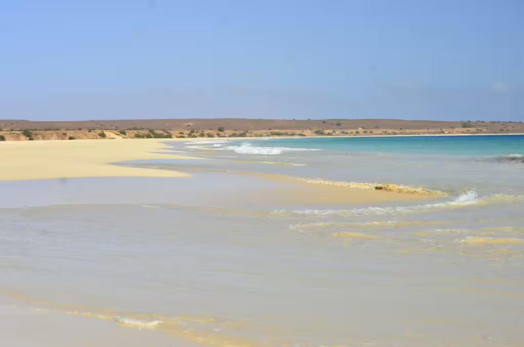 Vast coastal view of Santa Monica Beach with rolling waves and sandy shores on Boa Vista Island's quad tour route.
